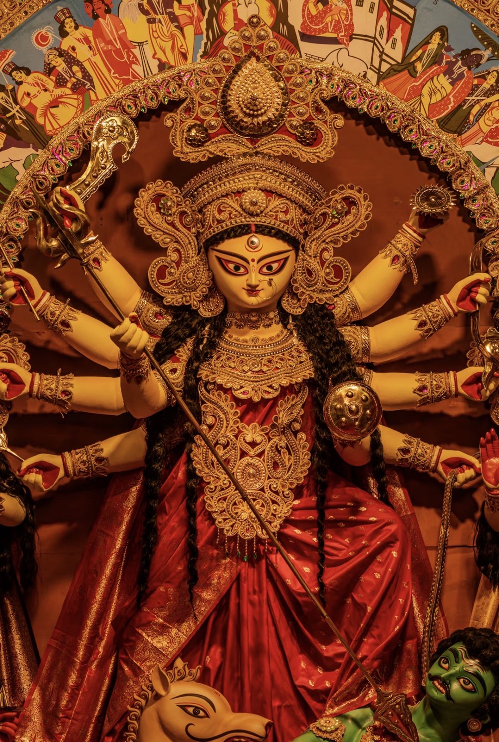 Devi Durga idol, richly adorned in gold jewelry and a red silk sari, worshipped during CTBA's Durga Puja celebrations